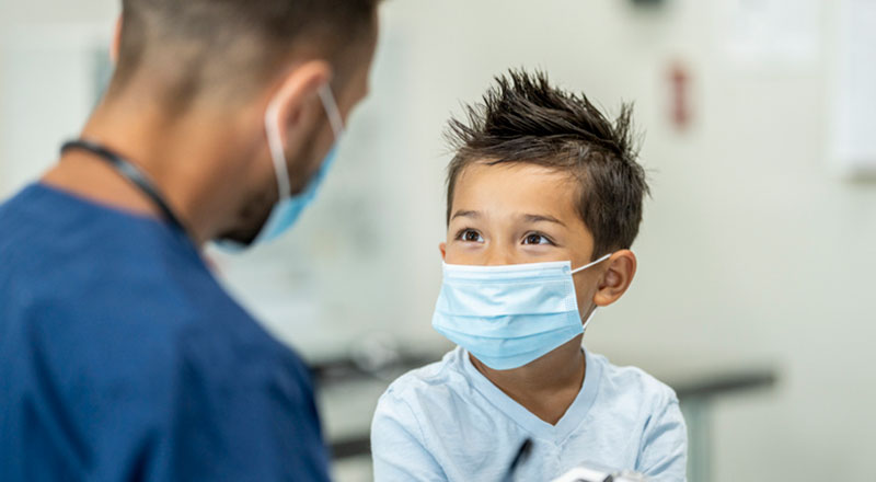 Child with mask on at dental office.